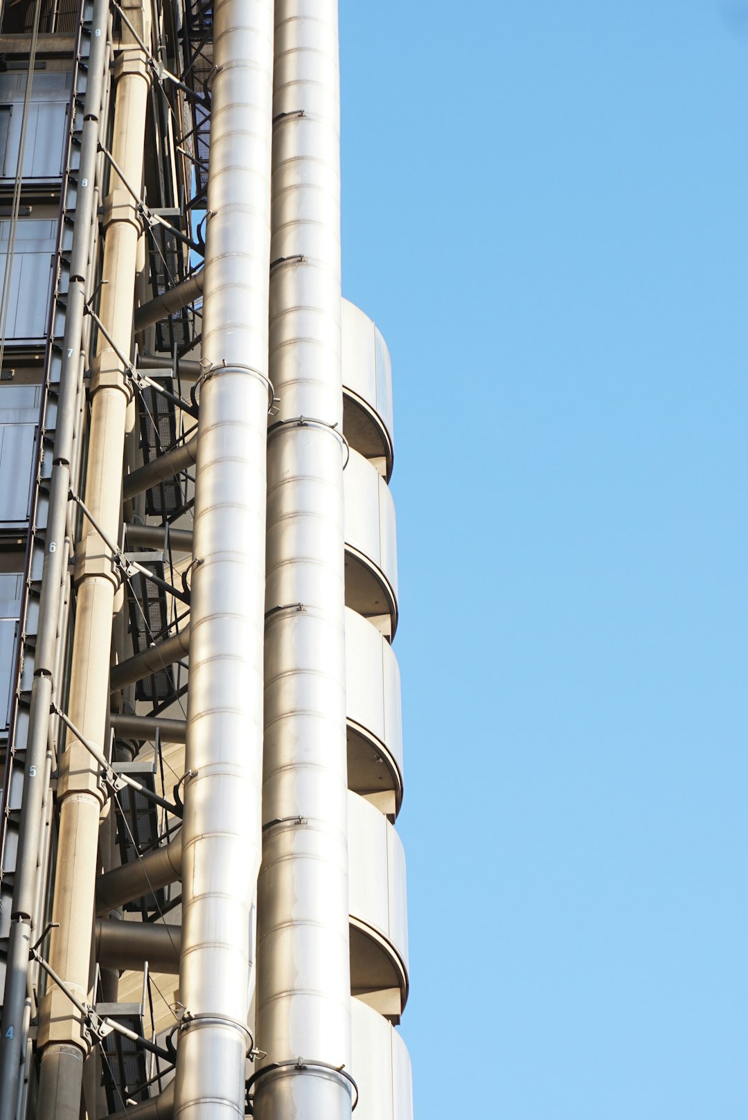 building with grey horizontal pipes during daytime