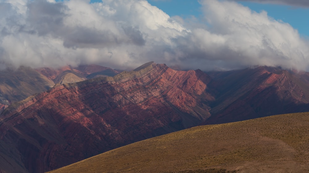 brown rocky mountain under white cloudy sky during daytime