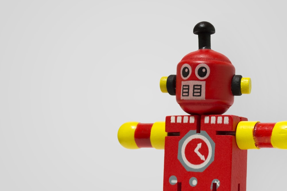 red and yellow robot clock toy