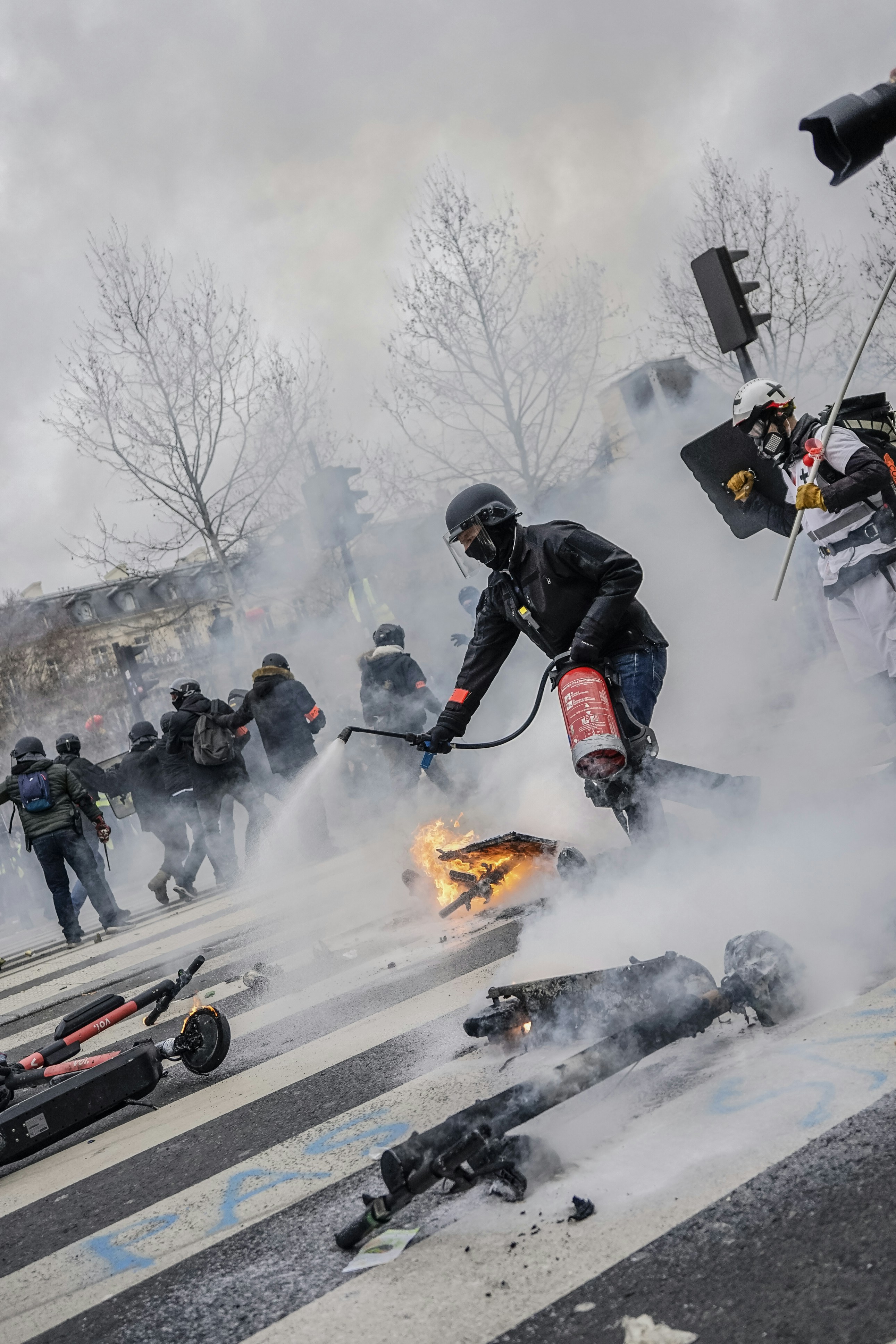 a group of people on a street with a fire extinguisher