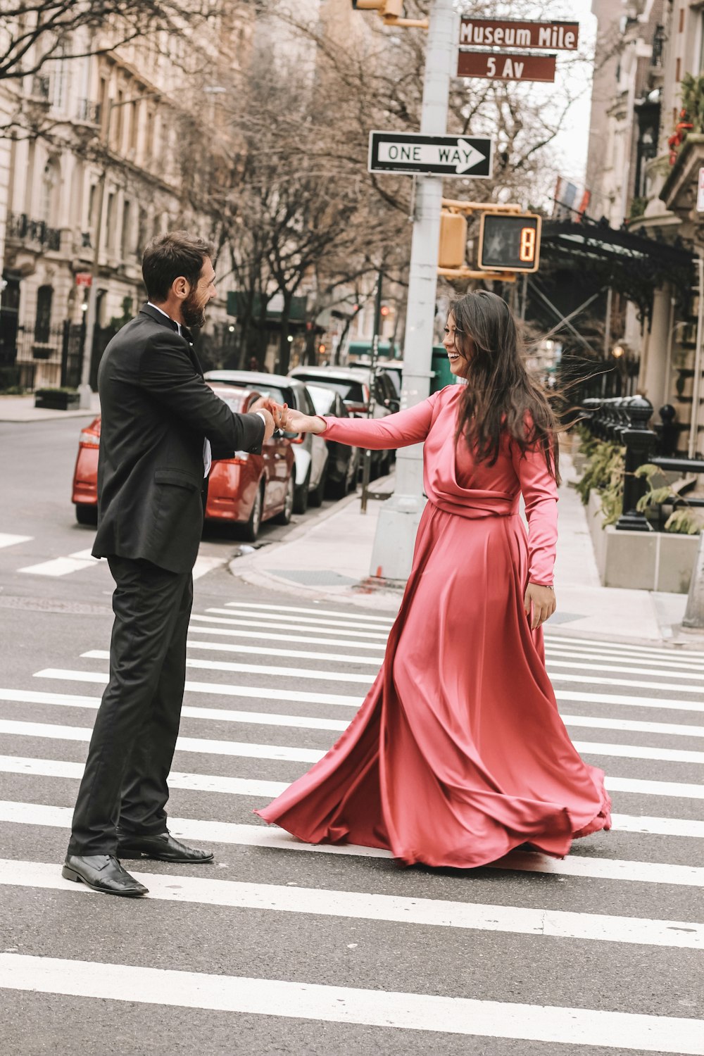 man and woman holding hands in road during daytime