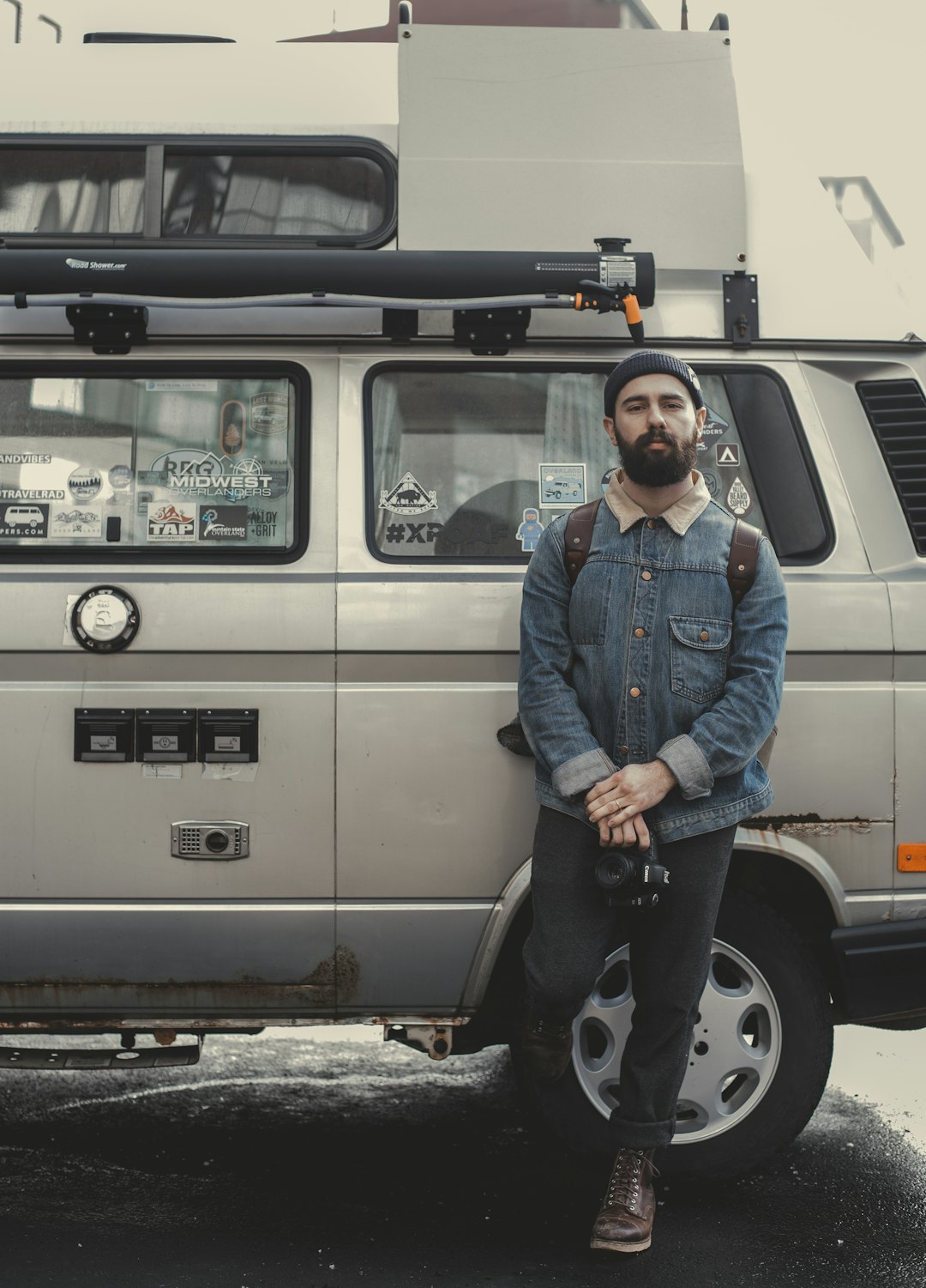 man leaning on silver SUV