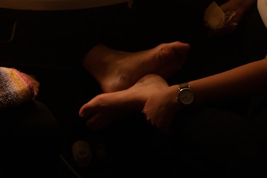 A friendly podiatrist gently examining a patient's foot in a bright, welcoming clinic room.