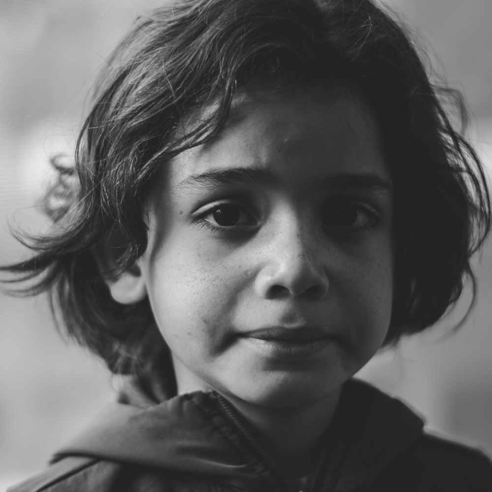 grayscale photography of boy in zip-up jacket