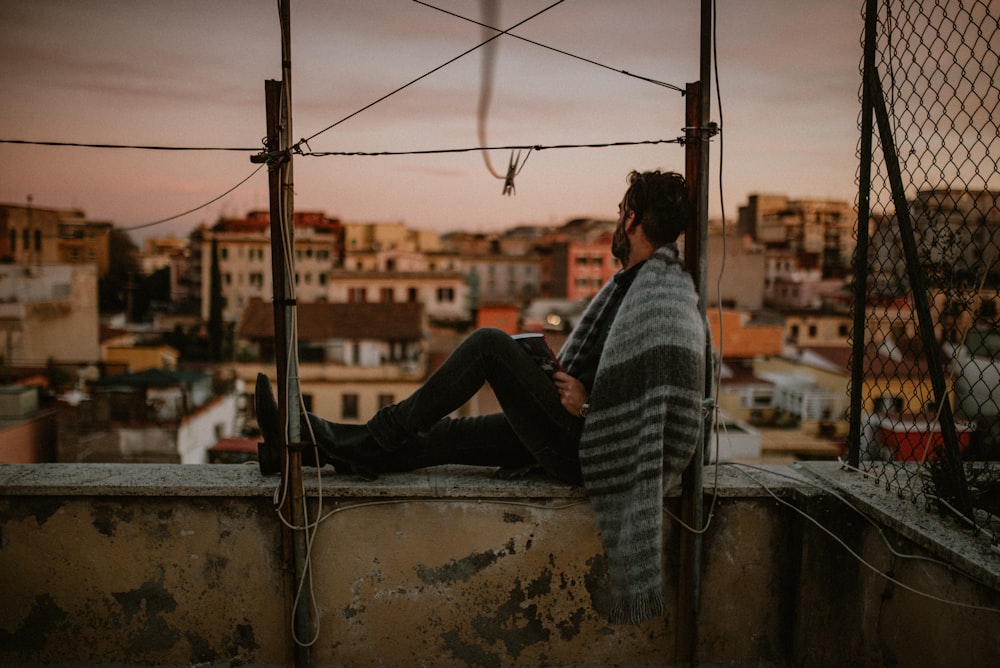 man in black and white stripe long sleeve shirt and black pants sitting on boat during