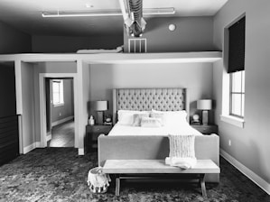 A beautifully arranged bedroom featuring a lift-up storage upholstered platform bed.