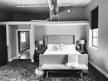 A plush storage ottoman bench placed at the foot of a bed, perfect for extra storage.