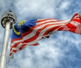 low angle photography of waving flag of Malaysia during daytime