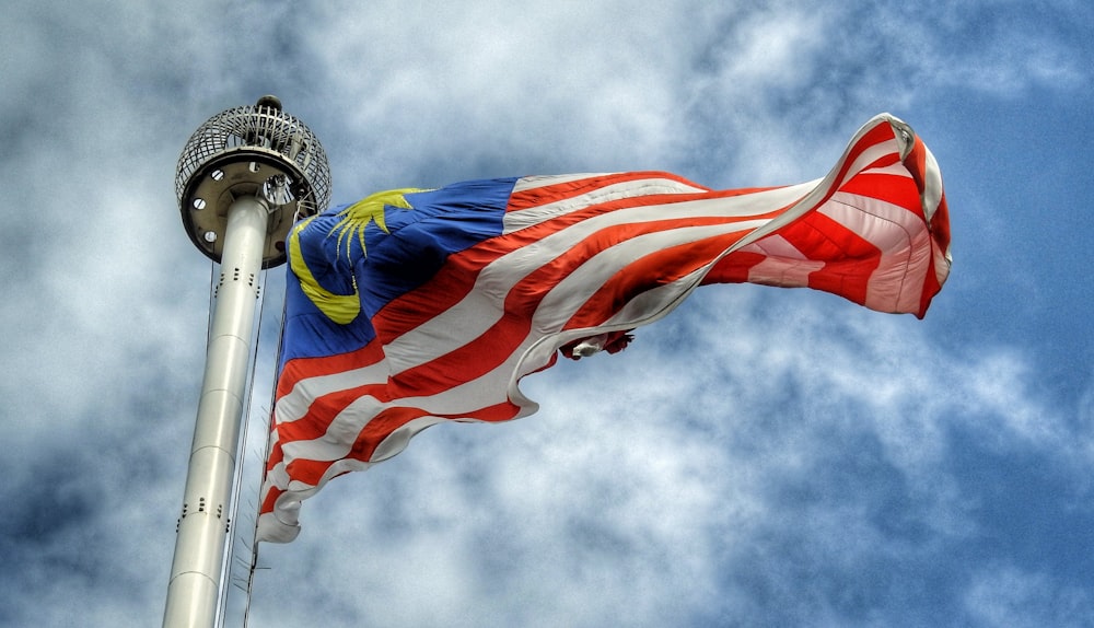 low angle photography of waving flag of Malaysia during daytime