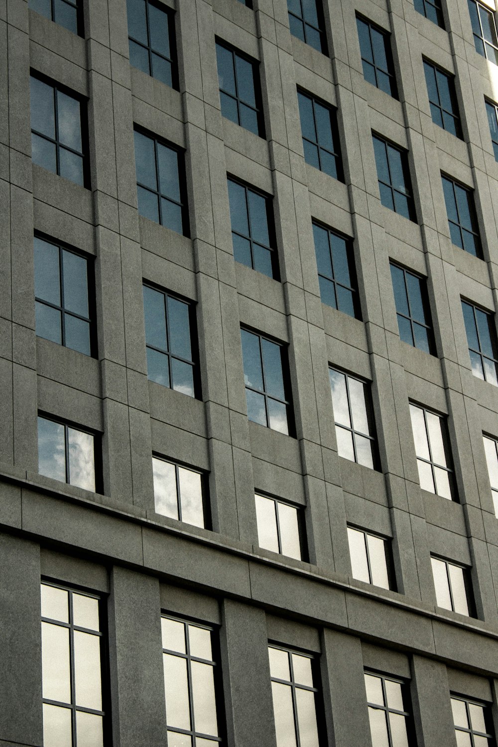 gray concrete building with glass close-up photo