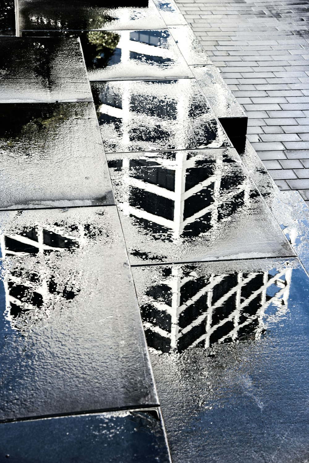 a building is reflected in a puddle of water