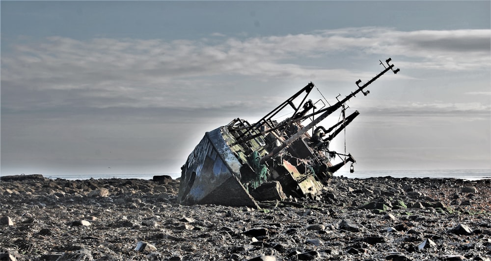 abandoned ship on rocky terrain during daytime