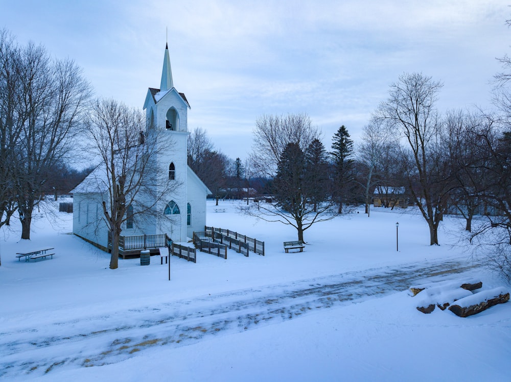 snow covered church under grey cloudy sky