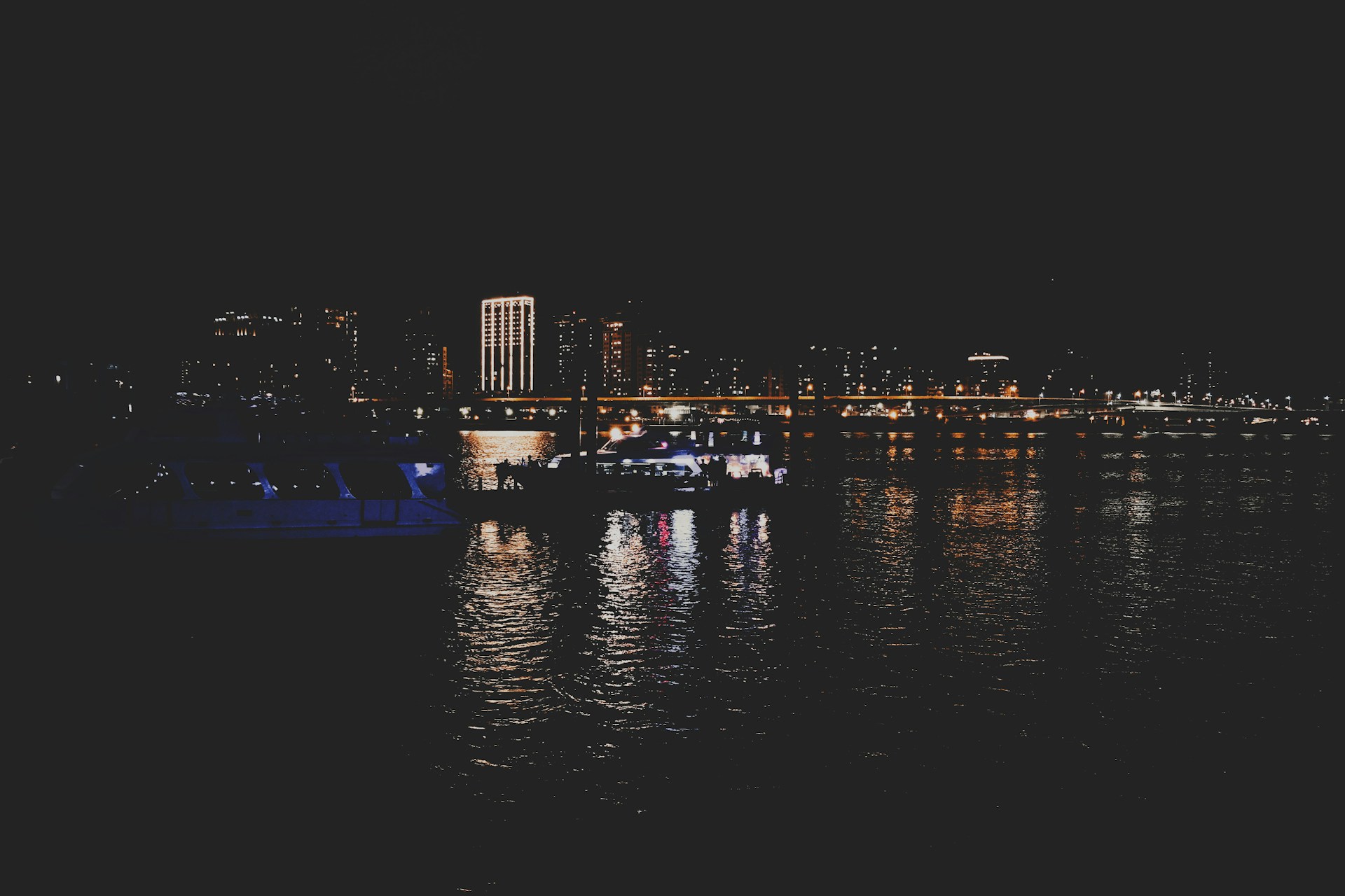 a boat floating on top of a body of water at night