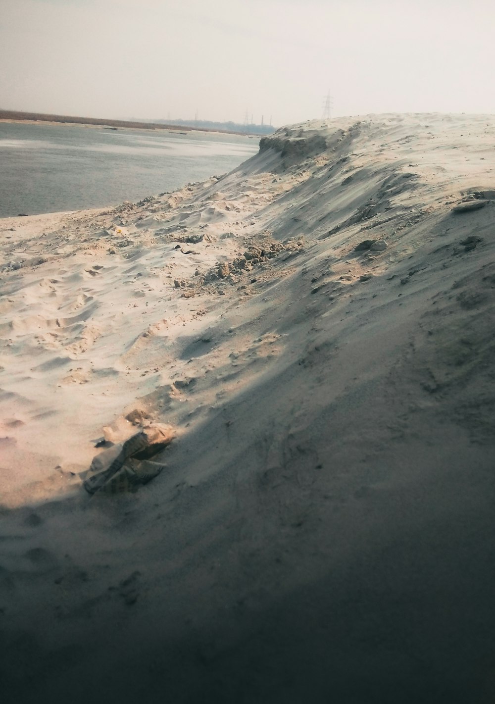 white sand near body of water during daytime