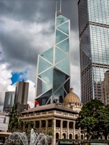 dome building beside glass high-rise building under gray sky