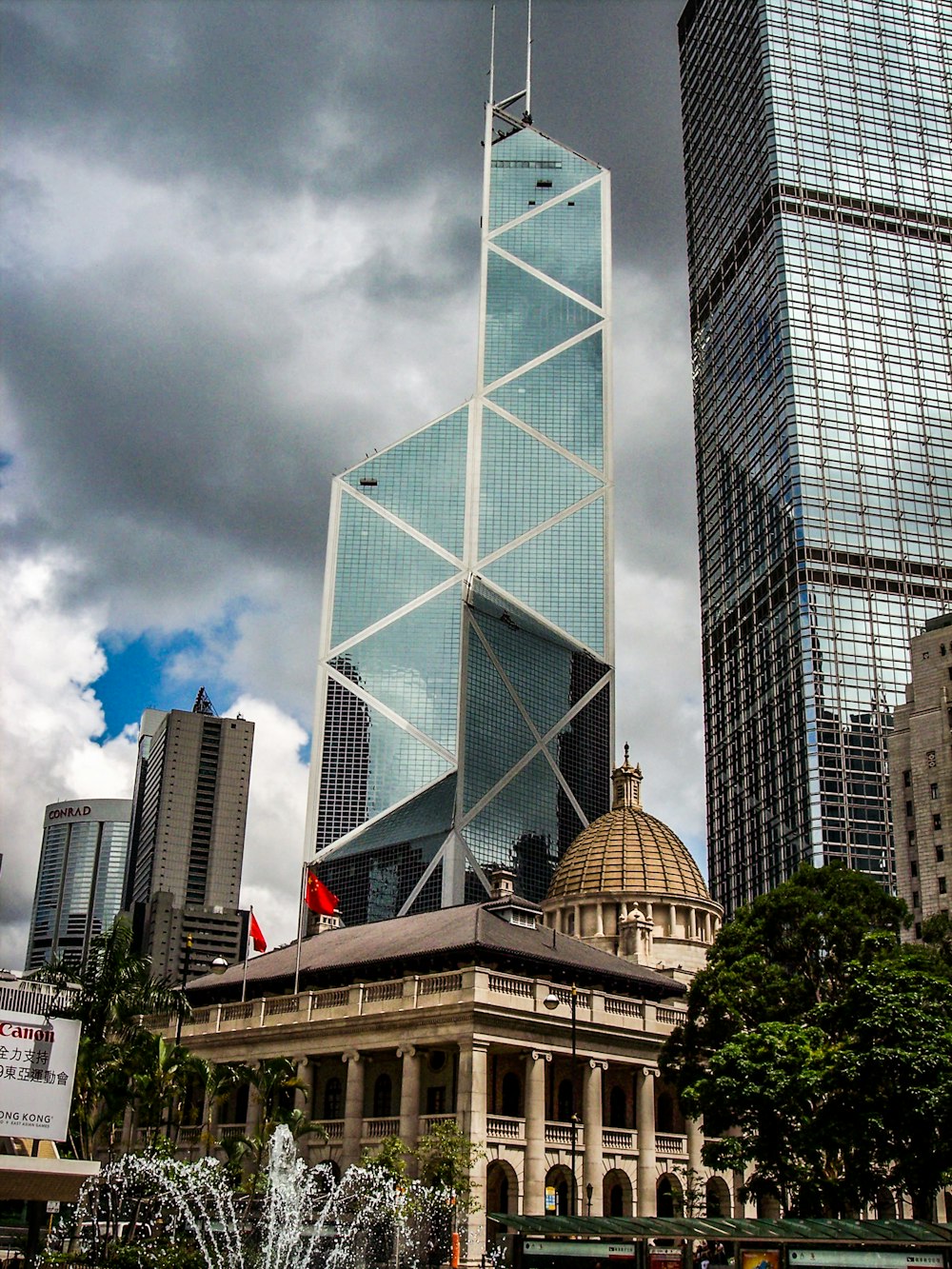 dome building beside glass high-rise building under gray sky