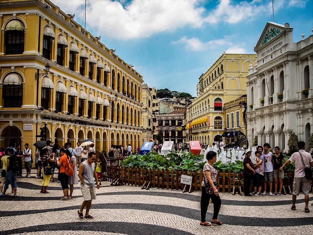 a group of people walking around a city square