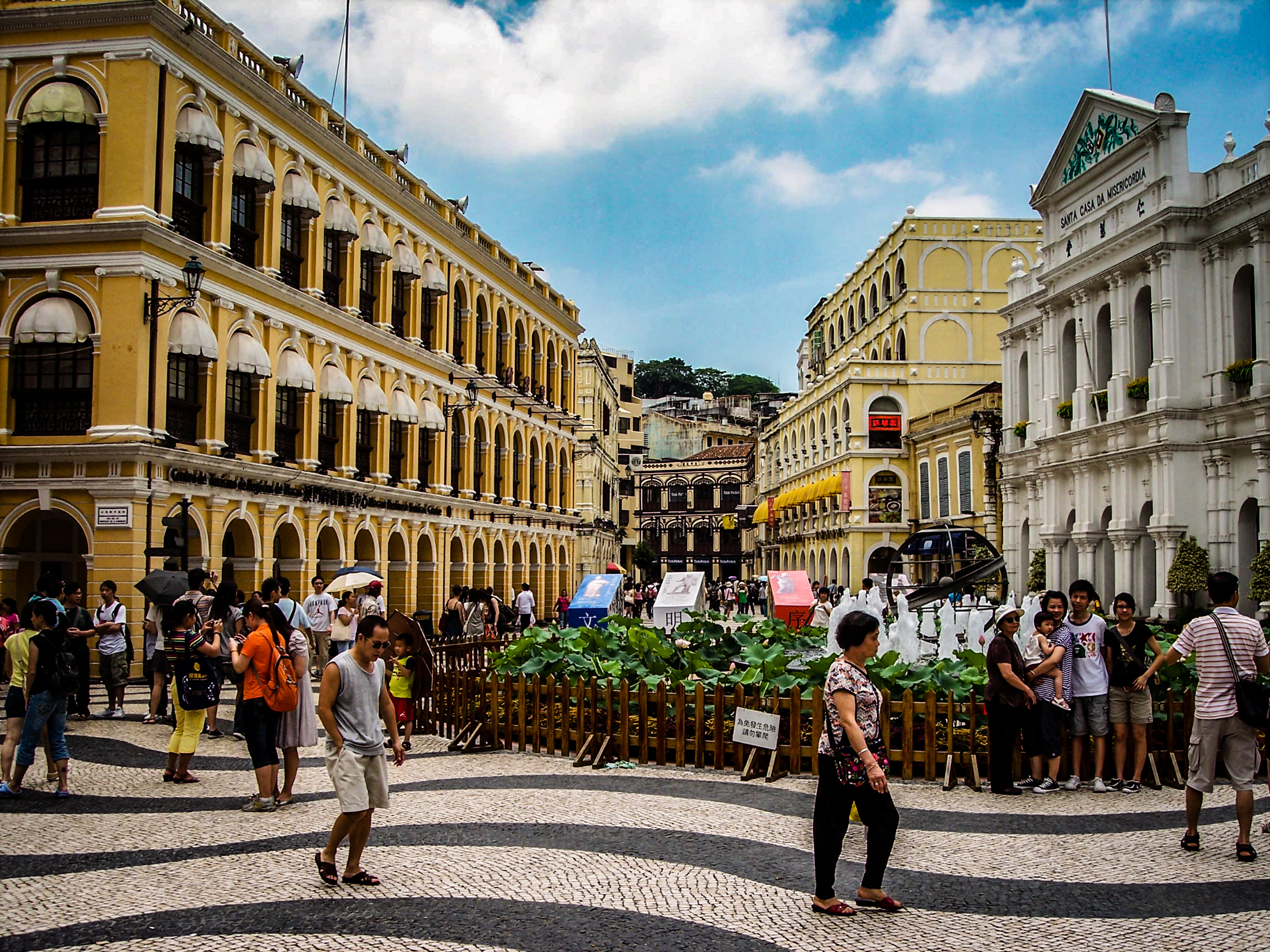 Wave-patterned paving and colonial façades on a square in Macau's historic centre