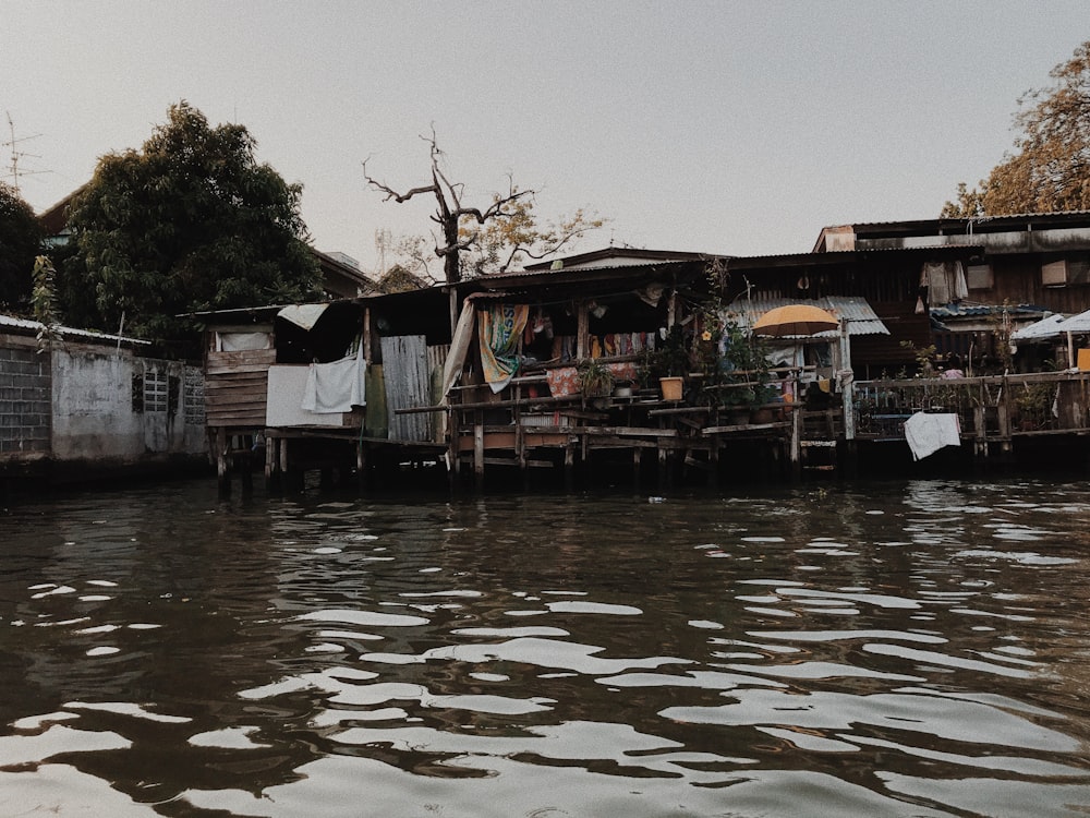 gray wooden house near body of water