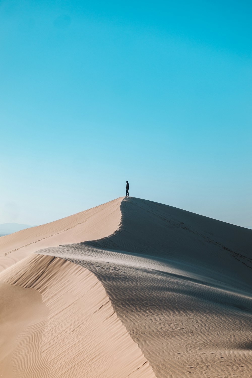 person standing on desert during daytime