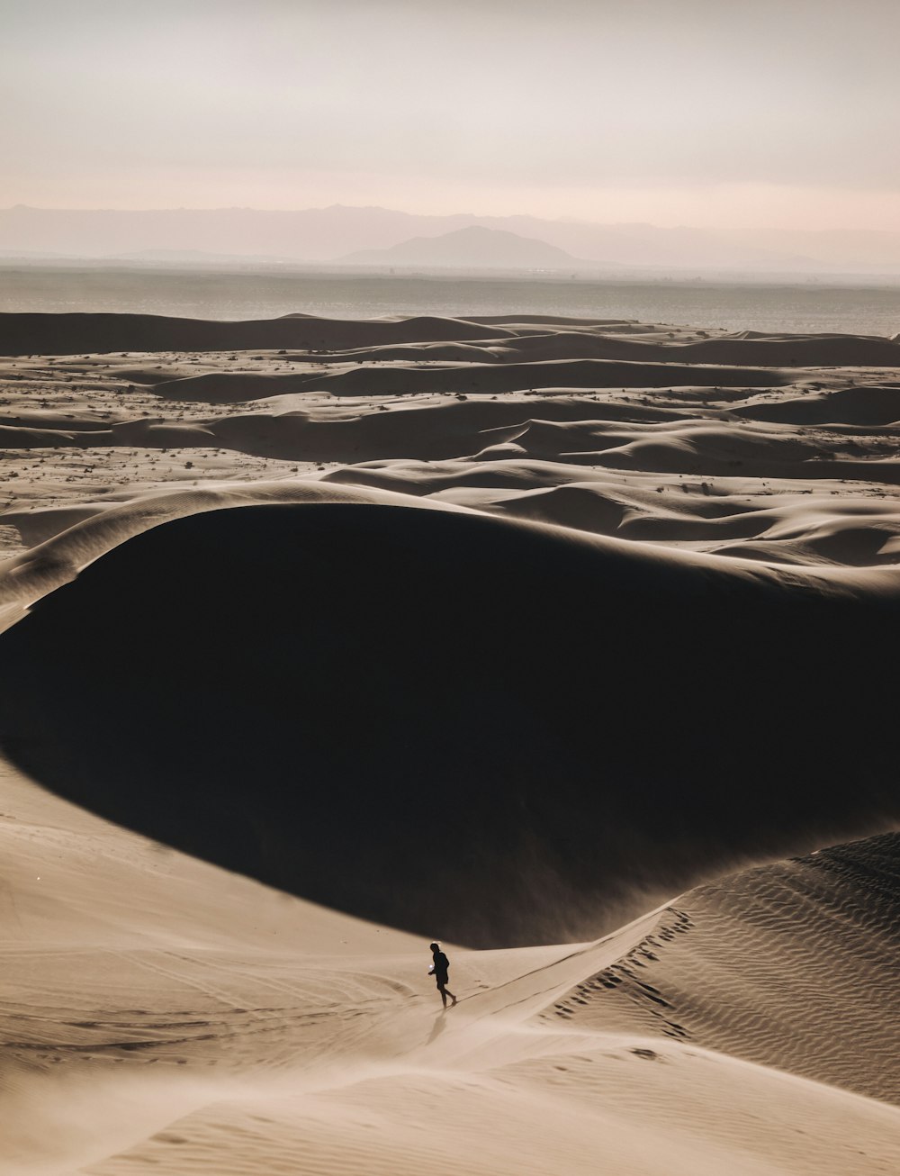 person walking on desert during daytime