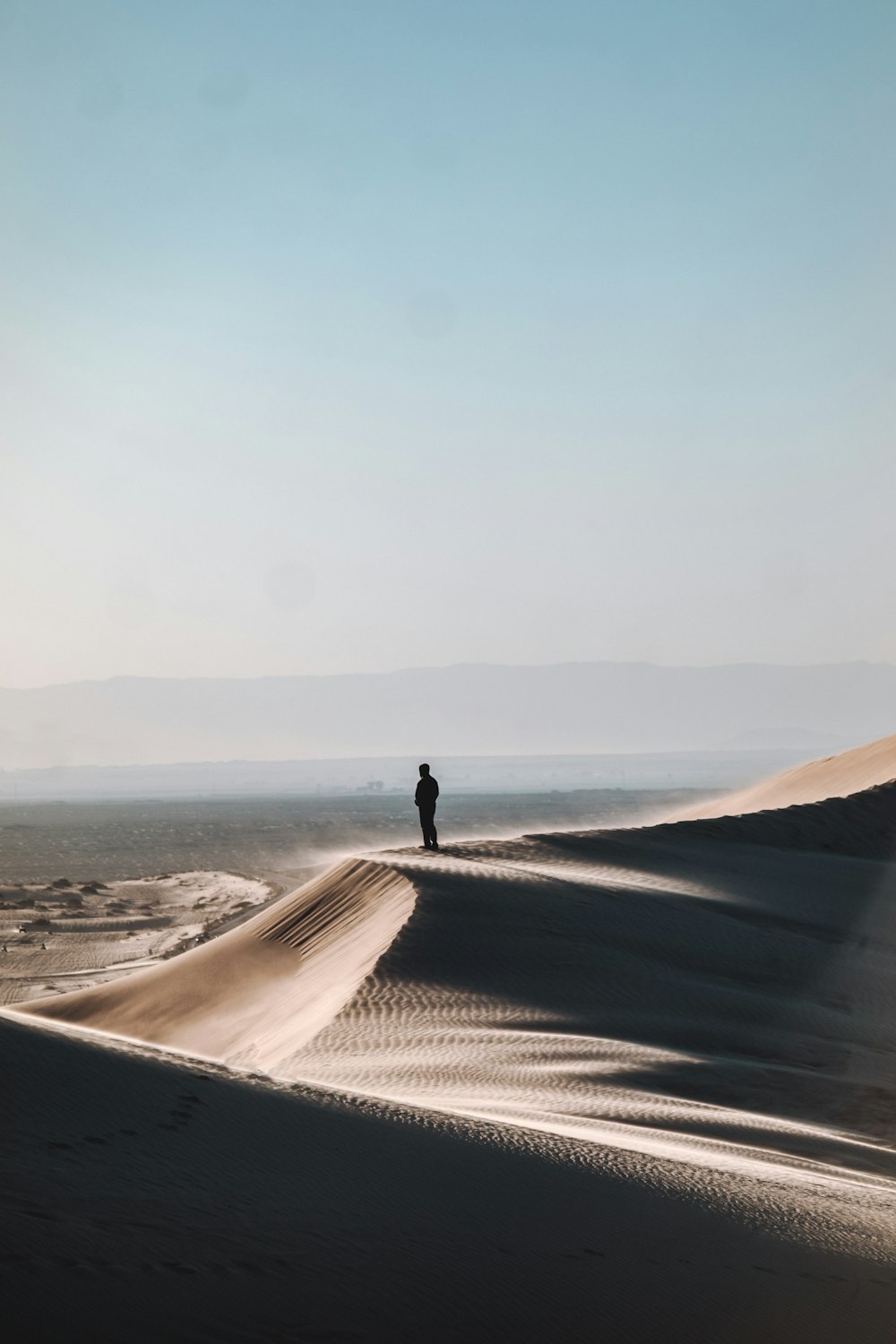 person standing on desert during daytime