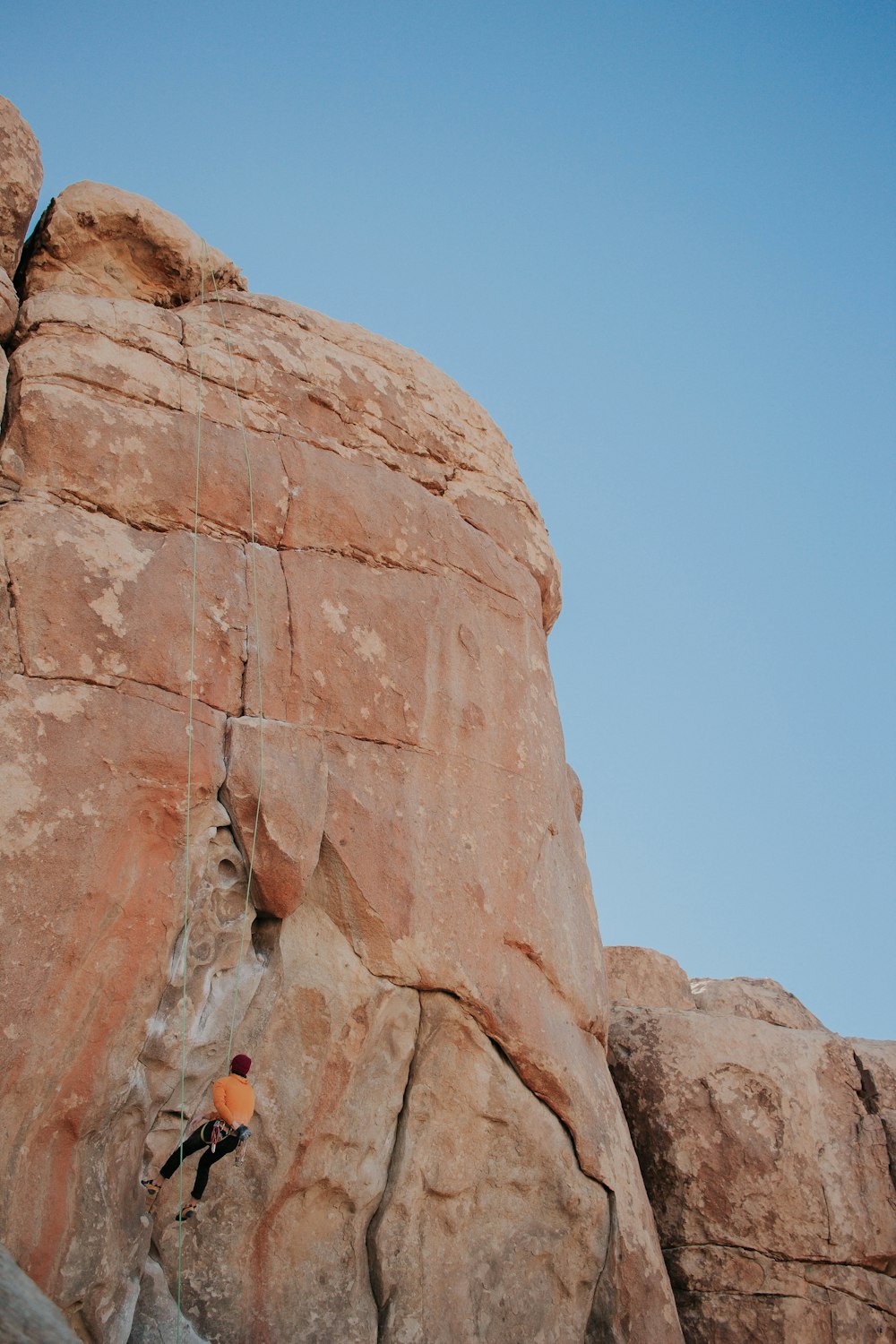 woman climbing on rock