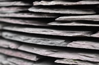 A close-up of slate tiles with unique textures.