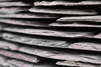 A close-up of slate tiles with unique textures.