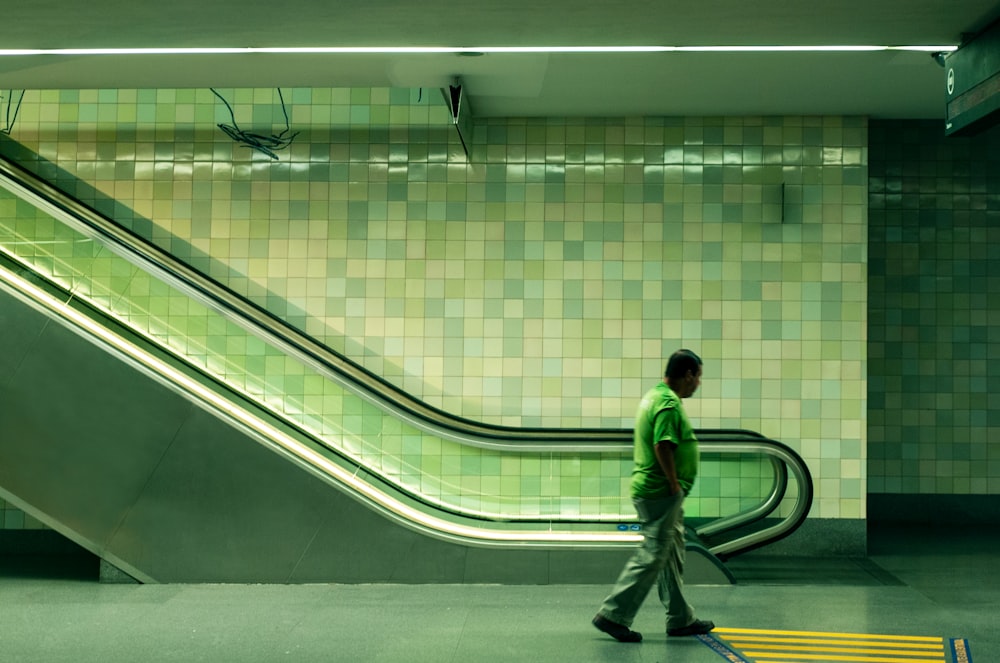 man walking beside escalator