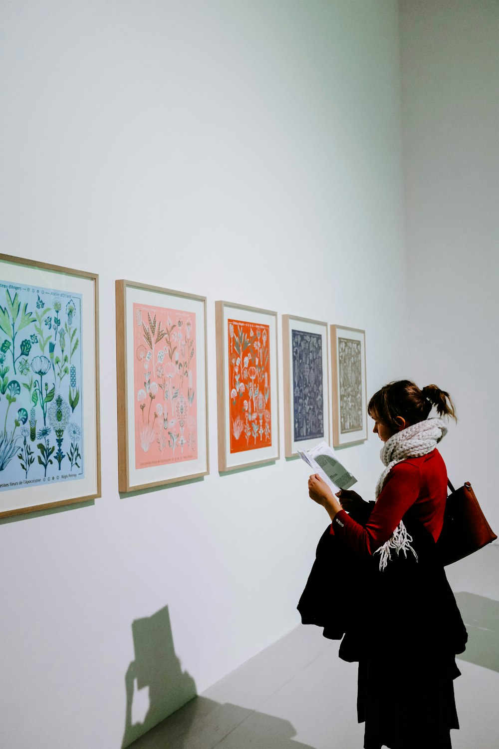 woman standing in front of paintings