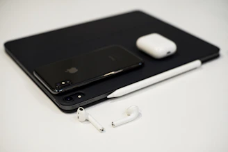 A sleek, minimalist display of modern tech gadgets on a clean white background.