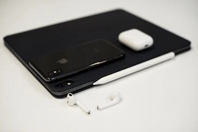 A collection of sleek mobile accessories including earbuds and chargers with glowing neon accents.