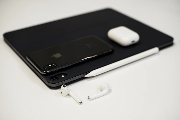 A sleek, minimalist display of modern tech gadgets on a clean white background.