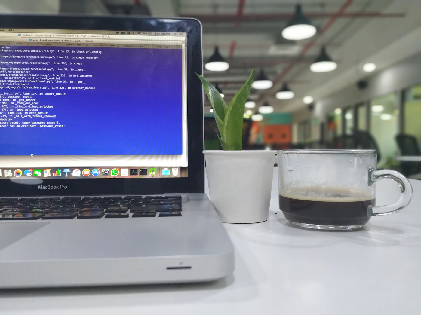 A laptop open on a desk in a technology workplace