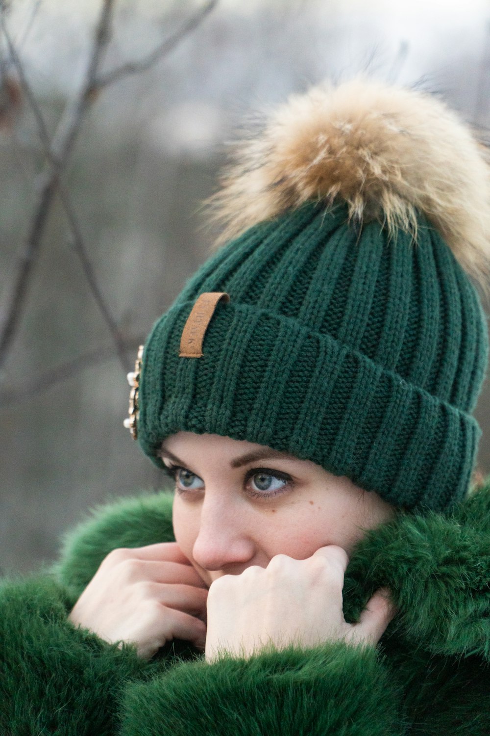 woman wearing bobble hat