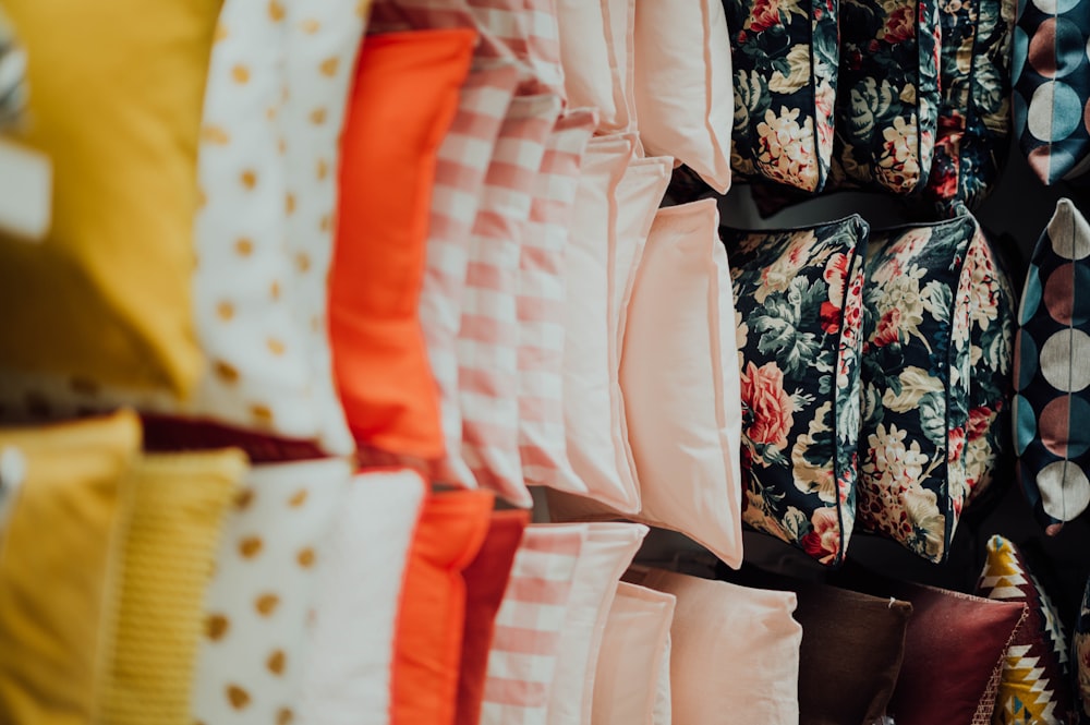 selective focus photography of assorted-color pillow lot