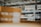 Shelves filled with neatly stacked cardboard boxes in a warehouse setting, with visible labels and numbers on each shelf. The focus is on organization and storage.