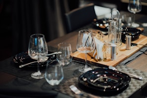 A well-arranged dining table set with elegant placemats and napkin holders from styliquee.