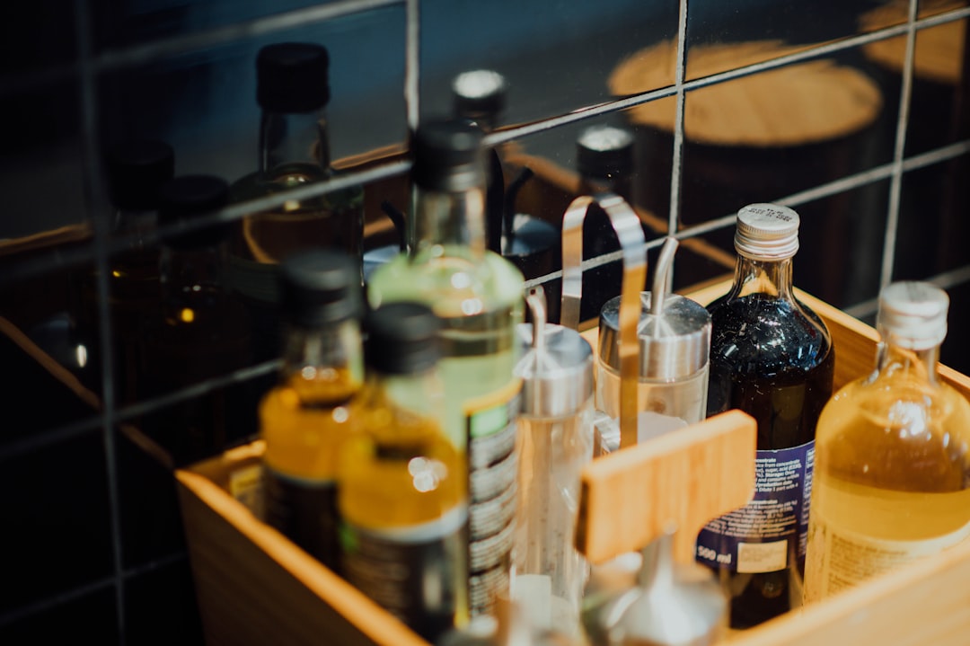 assorted glass bottles on brown wooden basket