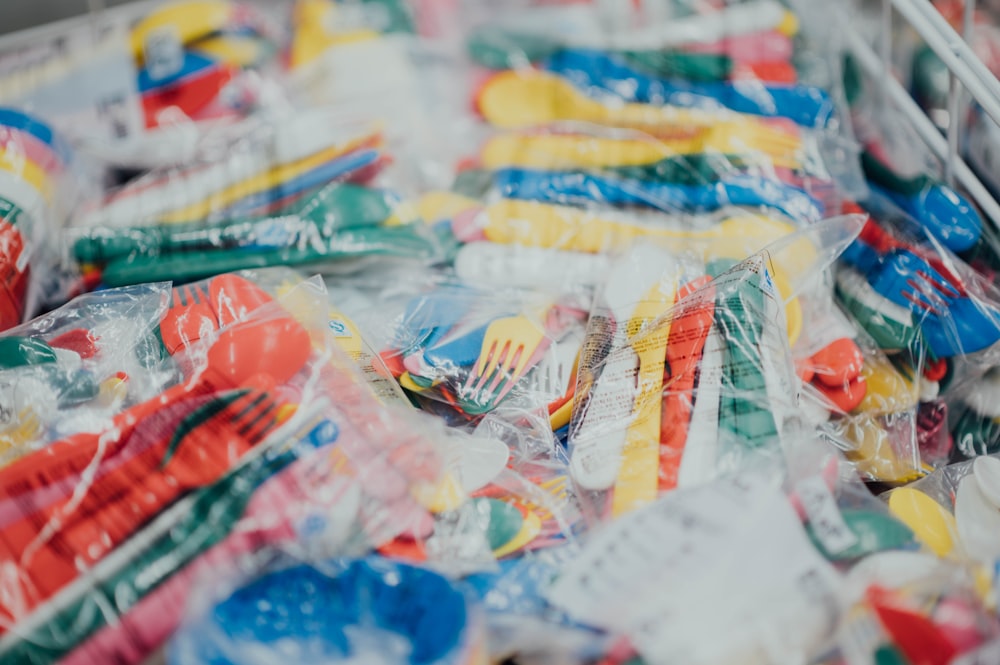 assorted-color plastic spoons and forks packs