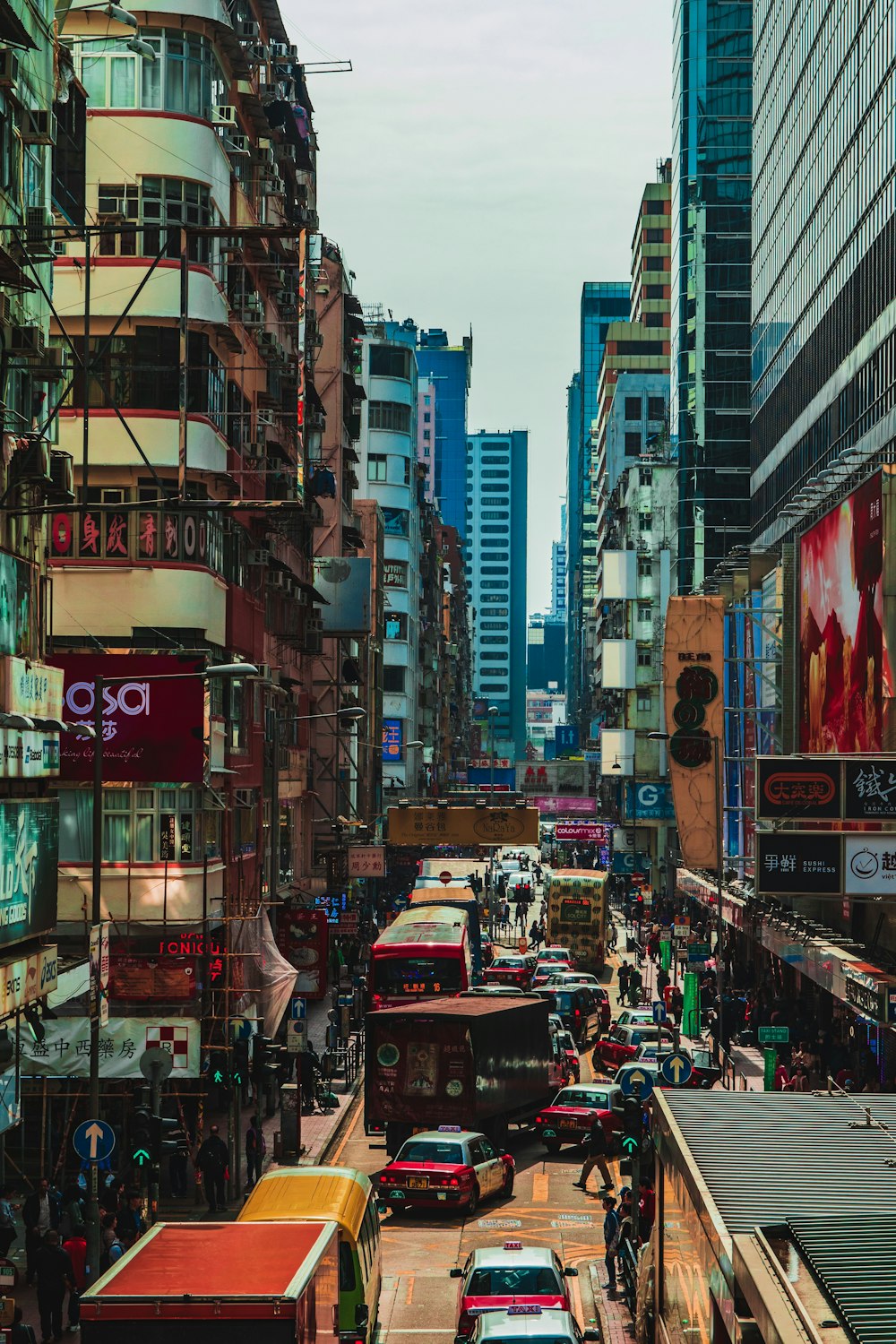 vehicles between high-rise buildings at daytime