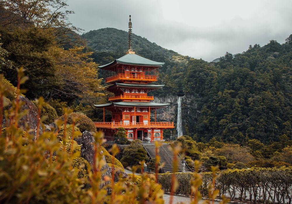 Edificio de pagoda marrón y azul rodeado de montañeses