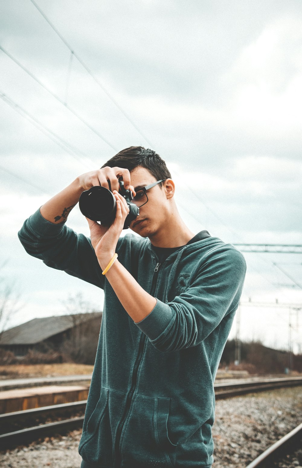 man wearing black jacket taking photo