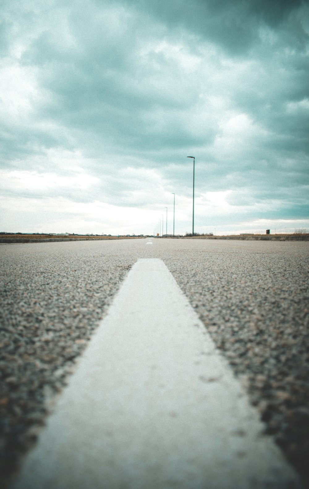 wide road under cloudy sky