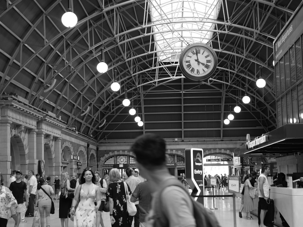 gray scale photo of people inside airport