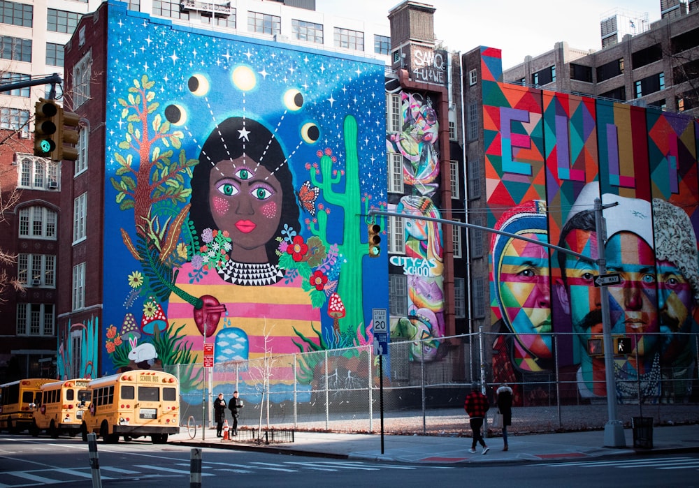 people walks beside multicolored building