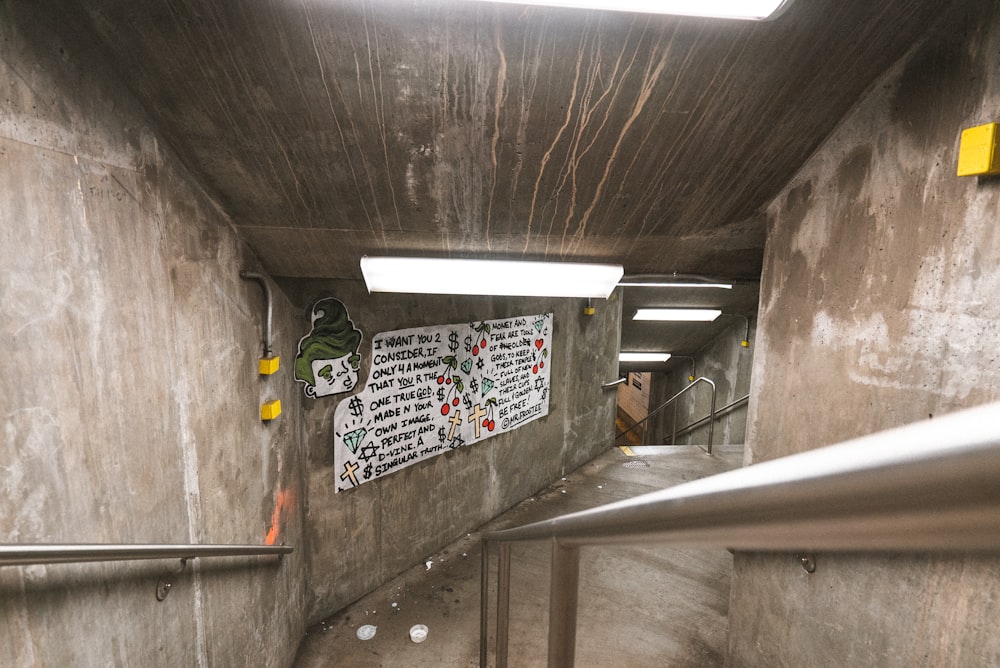 gray concrete pathway with wall signages