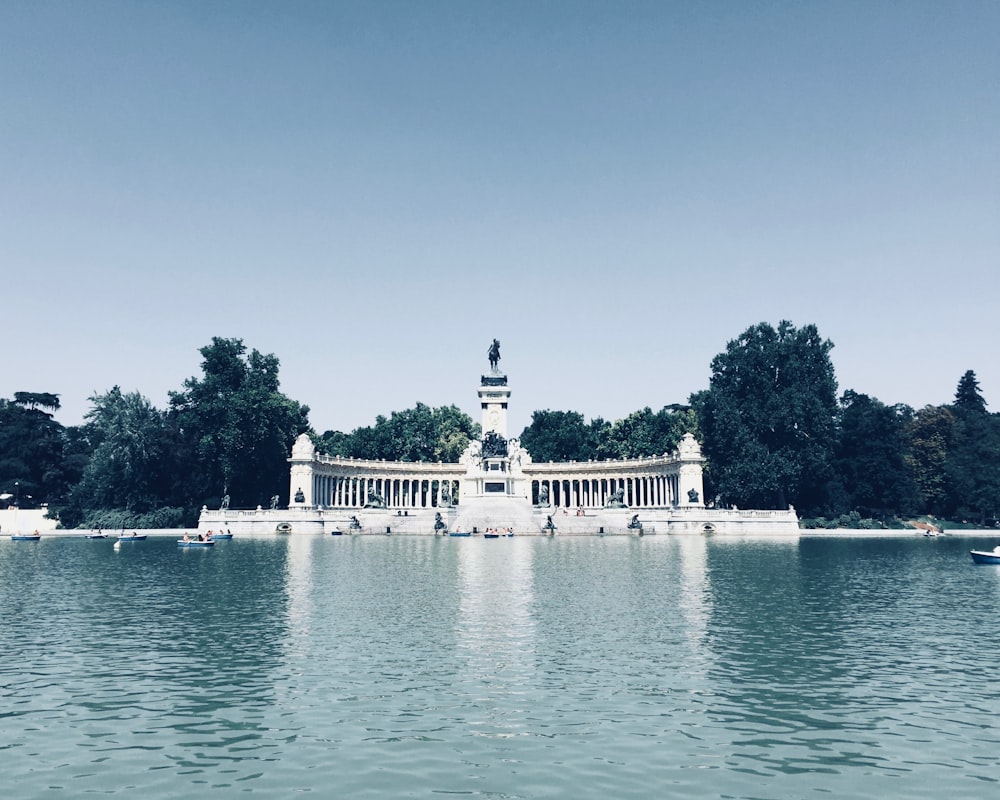 white concrete building near body of water during daytime